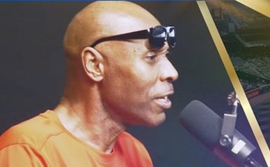 K-Rino speaking into a microphone during a Legends 34 taping.